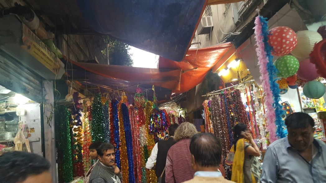 Bazaars, shadowed stores, bright flutter of silks and litter.